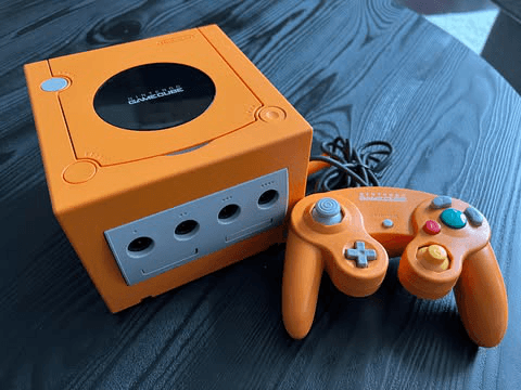 An orange GameCube and Controller