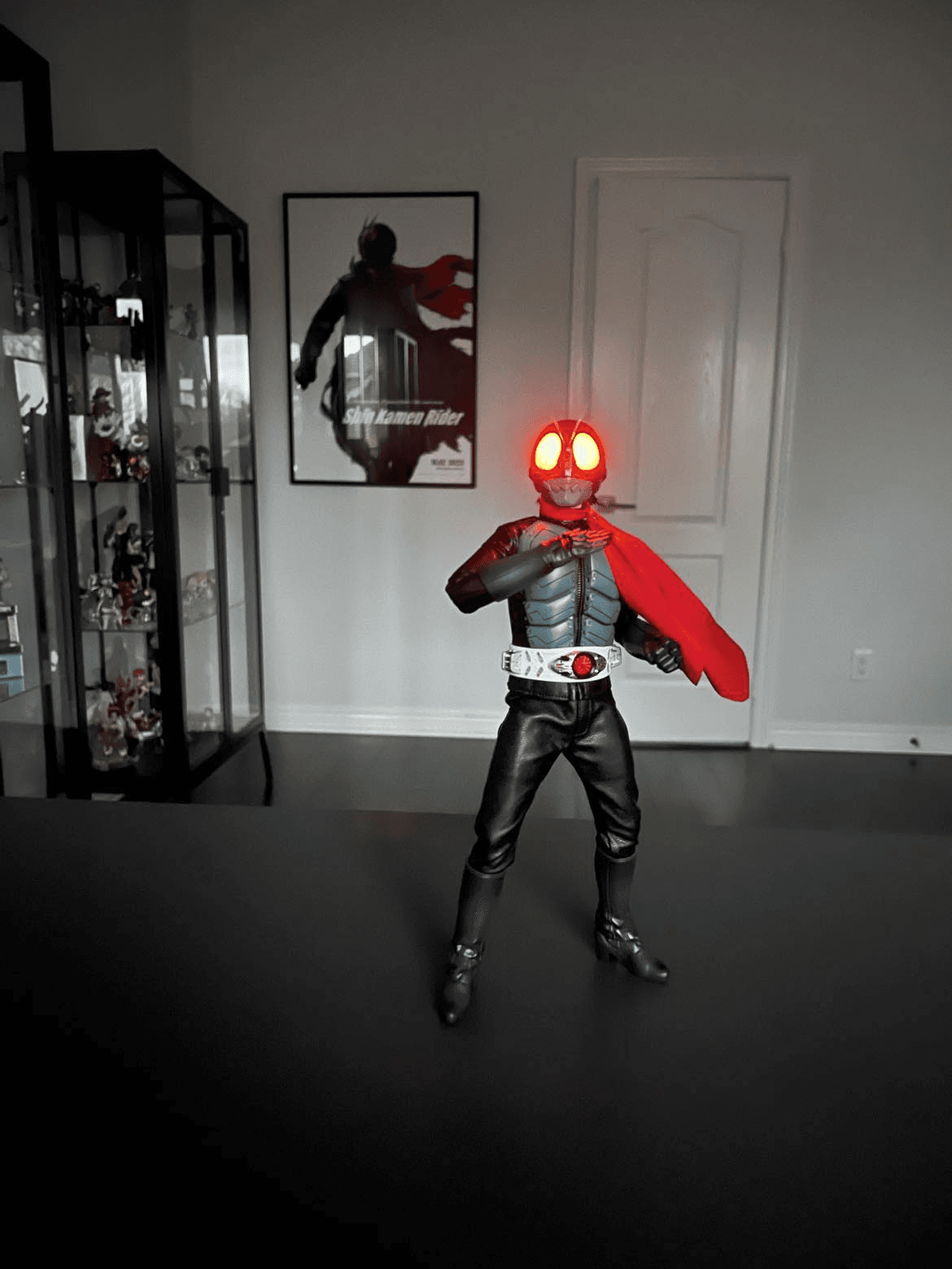 A kamen rider statue with glowing eyes